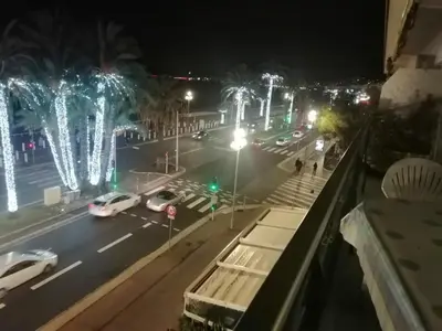 a city street at night with cars and christmas lights at PROMENADE HOLIDAY - SEA FRONT PALATIN in Nice
