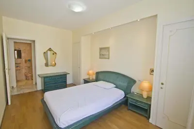 a small bedroom with a bed and a bathroom at PROMENADE HOLIDAY - SEA FRONT PALATIN in Nice