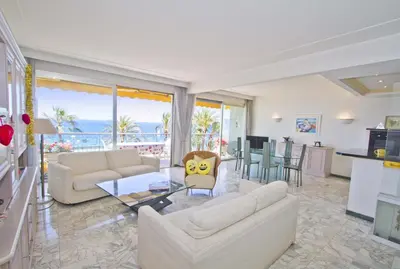 a living room with white furniture and a view of the ocean at PROMENADE HOLIDAY - SEA FRONT PALATIN in Nice