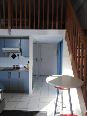 a kitchen with a table and a counter top at Aida - rue Bosio in Nice