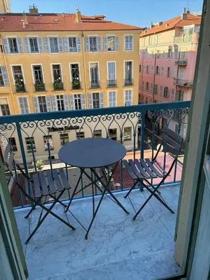 a small kitchen with blue cabinets and a staircase at Aida - rue Bosio in Nice