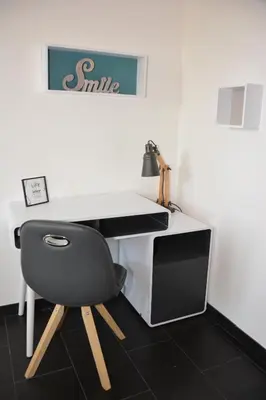 a desk with a chair in front of a wall at Villa ZEN in Saint-Laurent-du-Var
