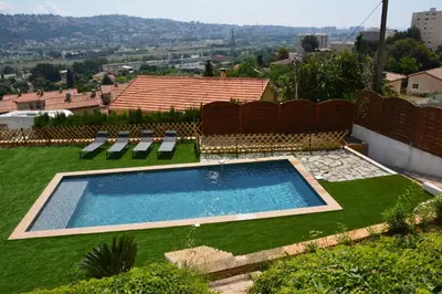 a swimming pool in the yard of a house at Villa ZEN in Saint-Laurent-du-Var