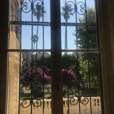 an open window with a view of a garden at Nice Apartment Roses & Ivy, Rue du Congres in Nice