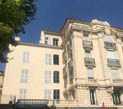 a large white building with balconies on it at Nice Apartment Roses & Ivy, Rue du Congres in Nice