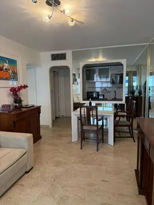 a kitchen with white cabinets and a plate of fruit on the counter at MASSENET VIEW AP4168 Nice, by Riviera Holiday Homes in Nice