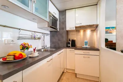 a hotel room with two beds and a mirror at MASSENET VIEW AP4168 Nice, by Riviera Holiday Homes in Nice