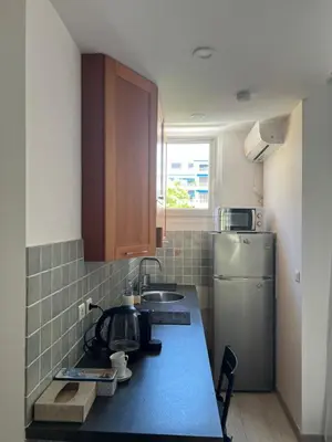 a kitchen with a blue counter top and a refrigerator at Chez Eva in Nice