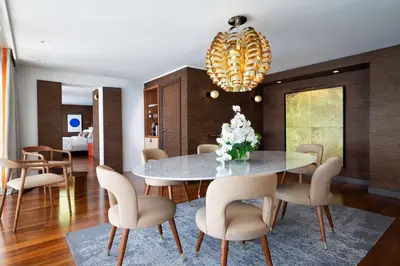 a dining room with a table and chairs at Le Meridien Nice in Nice