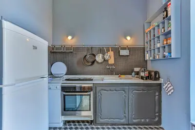 a kitchen with a stove and a sink and a refrigerator at Maison Bianchi - 24 Paul Deroulede in Nice