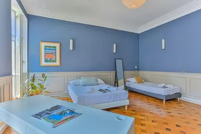 a room with two beds and a blue wall at Maison Bianchi - 24 Paul Deroulede in Nice
