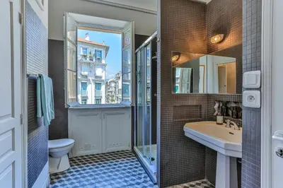 a bathroom with a sink and a toilet and a mirror at Maison Bianchi - 24 Paul Deroulede in Nice