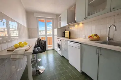 a kitchen with a sink and a dishwasher at Port, vue mer et confort et parking in Nice