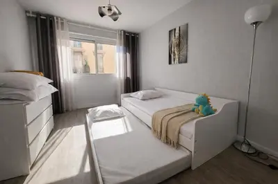 a bedroom with a bed with a teddy bear sitting on it at Port, vue mer et confort et parking in Nice
