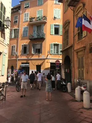 a group of people walking down a street with a building at STUDIO VIEILLE VILLE in Nice