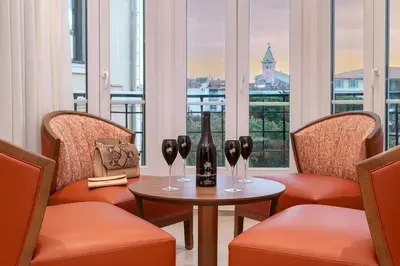 a room with chairs and a table with wine glasses at Résidence Aston la Scala in Nice