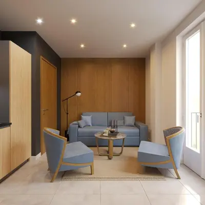 a living room with a couch and a table and chairs at Résidence Aston la Scala in Nice