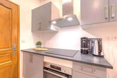 a kitchen with a counter top with a coffee maker at Lovely large familial apartment in central Nice, ten minutes walk to the beach! in Nice