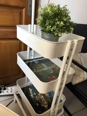 a white shelf with a plant and a book at Lovely large familial apartment in central Nice, ten minutes walk to the beach! in Nice