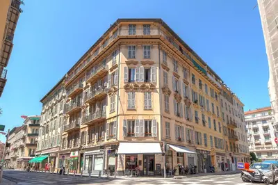 a large building on the corner of a street at Lovely large familial apartment in central Nice, ten minutes walk to the beach! in Nice