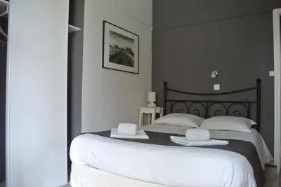 a bedroom with a bed with two white towels on it at Hotel Danemark in Nice