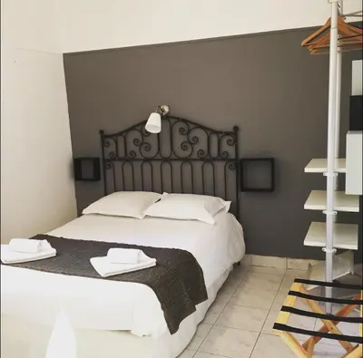 a bedroom with a large bed with white pillows at Hotel Danemark in Nice