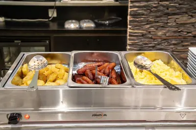 a buffet with four trays of food and spoons at Hotel Saint Georges in Nice