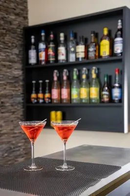 two martini glasses sitting on a table in a bar at Hotel Saint Georges in Nice