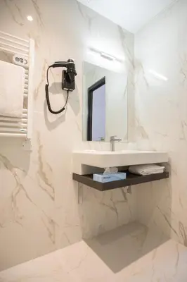 a bathroom with a sink and a mirror at Hotel Saint Georges in Nice