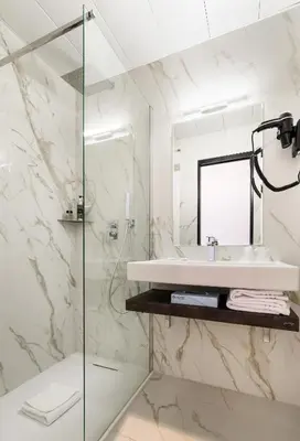 a bathroom with a sink and a mirror at Hotel Saint Georges in Nice