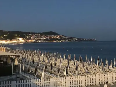 a bunch of umbrellas and chairs on a beach at LOFT 360° Nice in Nice