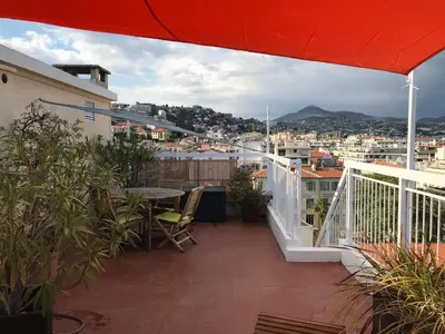 a balcony with a table and a view of a city at LOFT 360° Nice in Nice