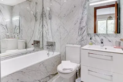 a white bathroom with a tub and a toilet and a sink at PROMENADE HOLIDAY - PALATIN PROMENADE in Nice