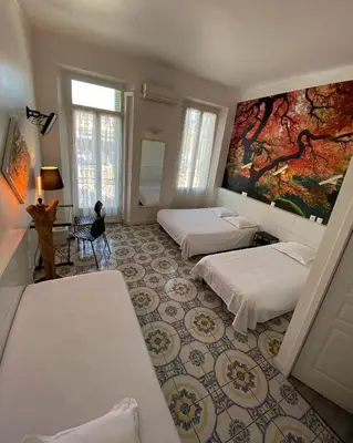 a room with two beds and a painting on the wall at Interlaken in Nice