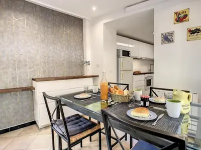 a dining room with a table and chairs and a kitchen at Nestor&Jeeves - ZEN - Central - Very close beaches in Nice
