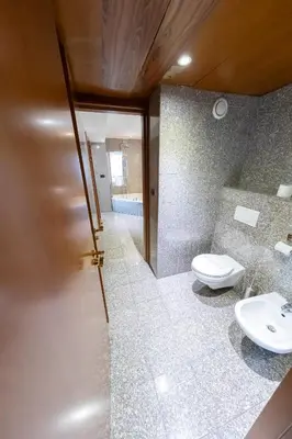 a bathroom with a toilet and two sinks at Goldstar Apartments & Suites in Nice