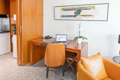 an office with a desk with a laptop and a chair at Goldstar Apartments & Suites in Nice
