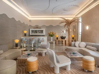a living room with couches and a fireplace at Hôtel Le Soleia by Inwood Hotels in Nice