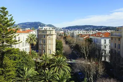 a view of a city with buildings and palm trees at Hôtel Le Soleia by Inwood Hotels in Nice