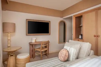 a living room with a tv and a couch and a table at Hôtel Le Soleia by Inwood Hotels in Nice