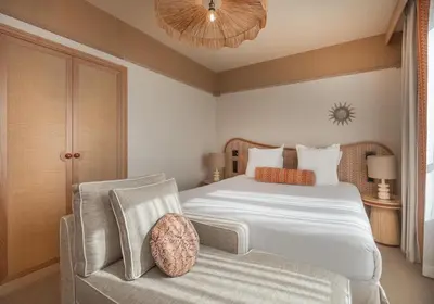 a bedroom with a large bed and a chair at Hôtel Le Soleia by Inwood Hotels in Nice