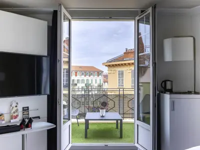 a hotel room with a bed and a television at Mercure Nice Centre Grimaldi in Nice