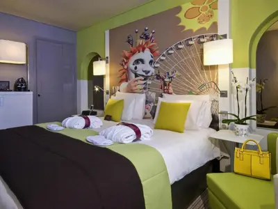 a hotel room with a bed and a desk and window at Mercure Nice Centre Grimaldi in Nice
