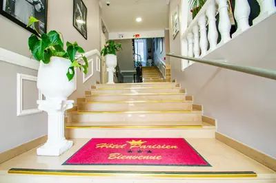 a red welcome mat on the floor of a staircase at Hôtel Parisien in Nice