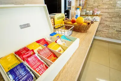 a refrigerator filled with food on top of a counter at Hôtel Parisien in Nice