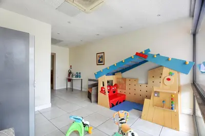a living room with a play room with a slide at Résidence Pierre & Vacances Heliotel Marine in Saint-Laurent-du-Var