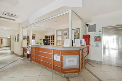 a store with a counter in a room at Résidence Pierre & Vacances Heliotel Marine in Saint-Laurent-du-Var