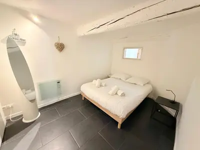 a bedroom with a bed with two towels on it at La Rose: Charming 2-room apartment in the heart of Nice - 3-min. from the beach in Nice