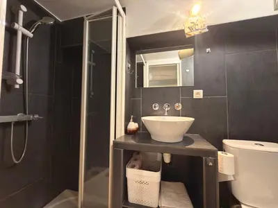 a bathroom with a sink and a shower and a toilet at La Rose: Charming 2-room apartment in the heart of Nice - 3-min. from the beach in Nice