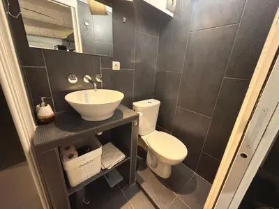 a small bathroom with a sink and a toilet at La Rose: Charming 2-room apartment in the heart of Nice - 3-min. from the beach in Nice